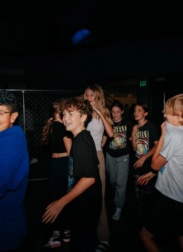 Students laughing at an evening event.