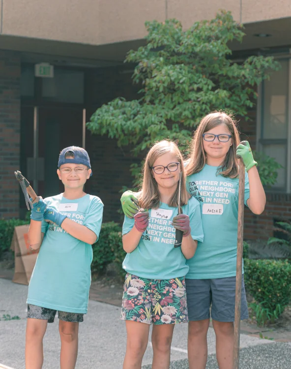 Three students volunteering together.