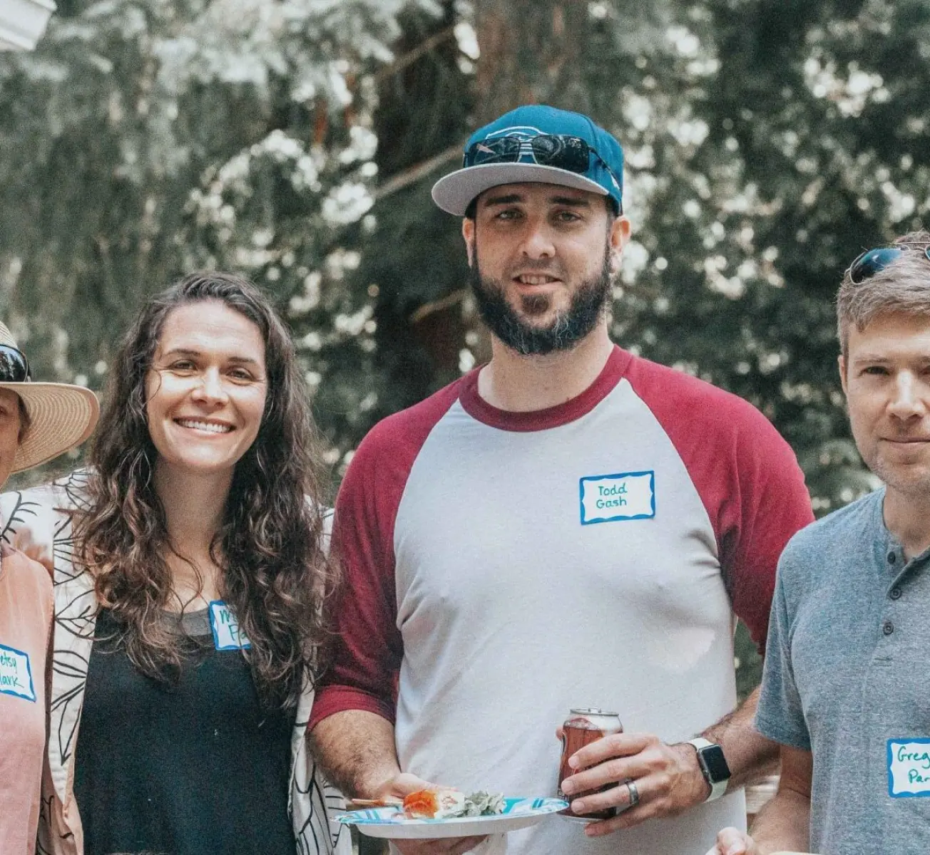A group gathering outdoors with food.