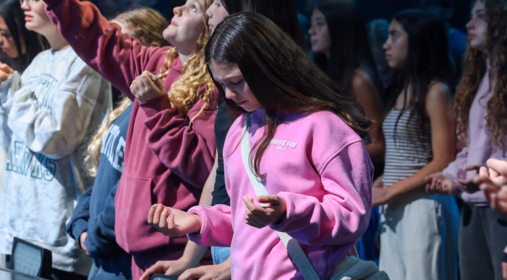 students worshipping Jesus