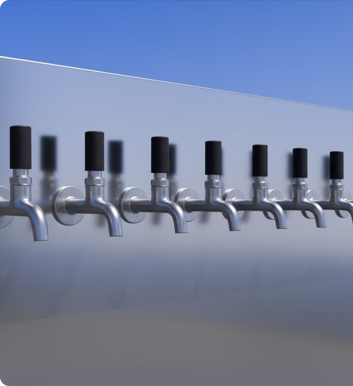 Row of metal beer taps with black handles mounted on a reflective surface under clear blue sky.