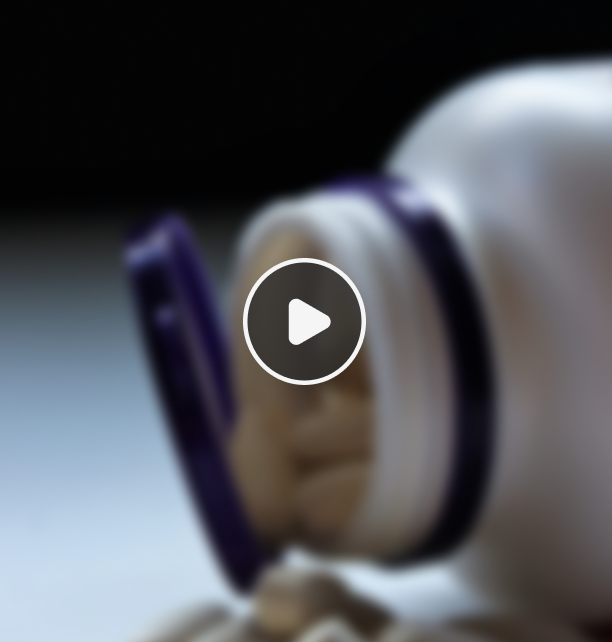 White pill bottle with purple cap open and beige capsules spilling out on a surface.