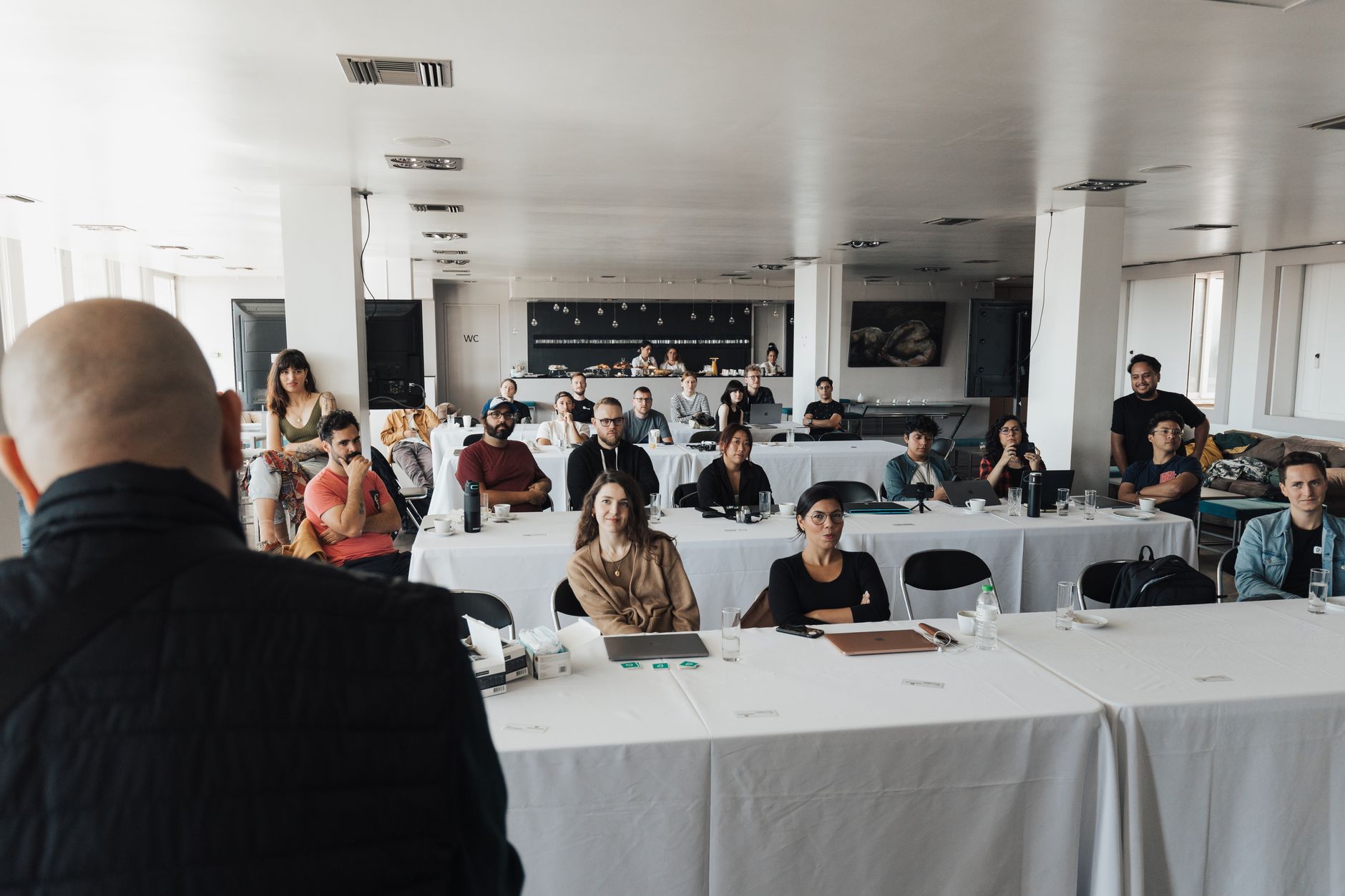 Instructor leading a training session for an attentive room of professionals