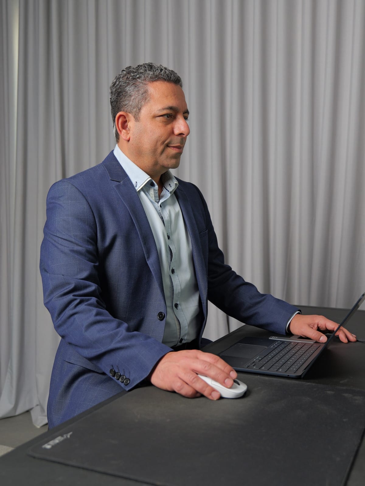 Dr Nader Malik working at a computer