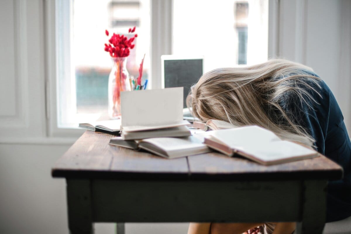 Exhausted healthcare professional at her desk showing signs of burnout