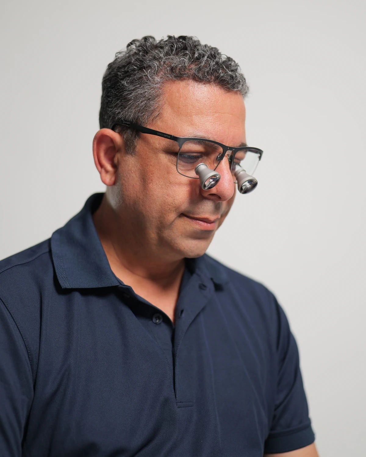 Close-up of Dr Nader Malik wearing dental loupes