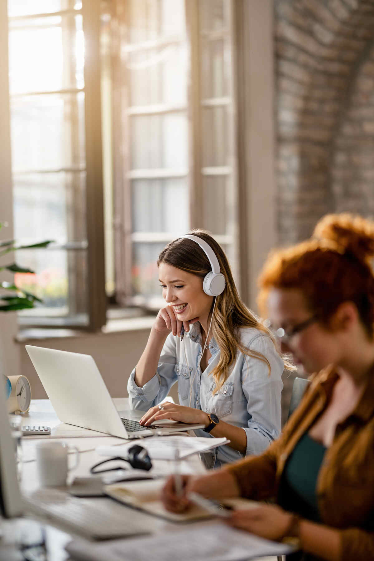 Healthcare professional studying with a laptop and headphones