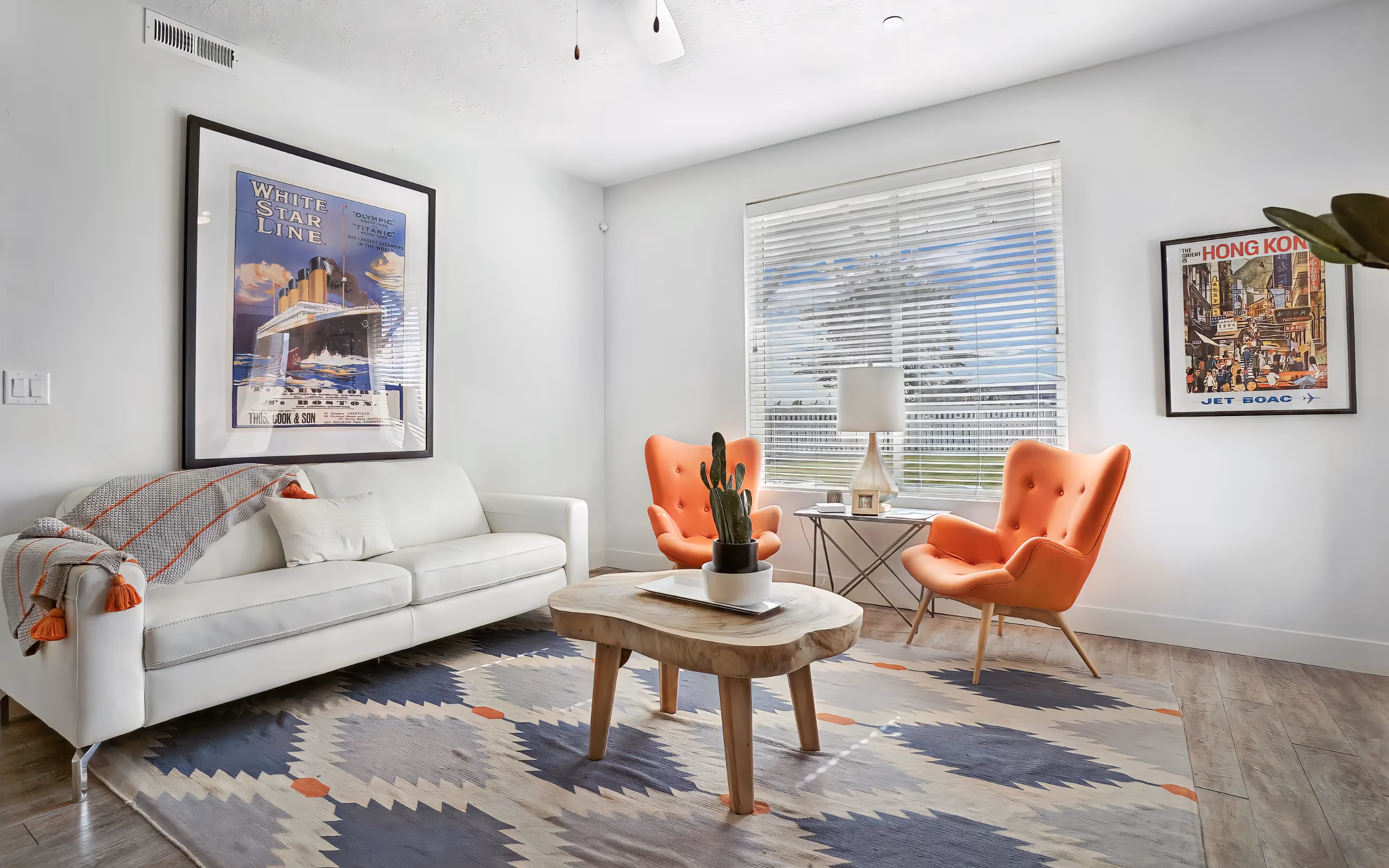 Living room with white sof and orange chairs