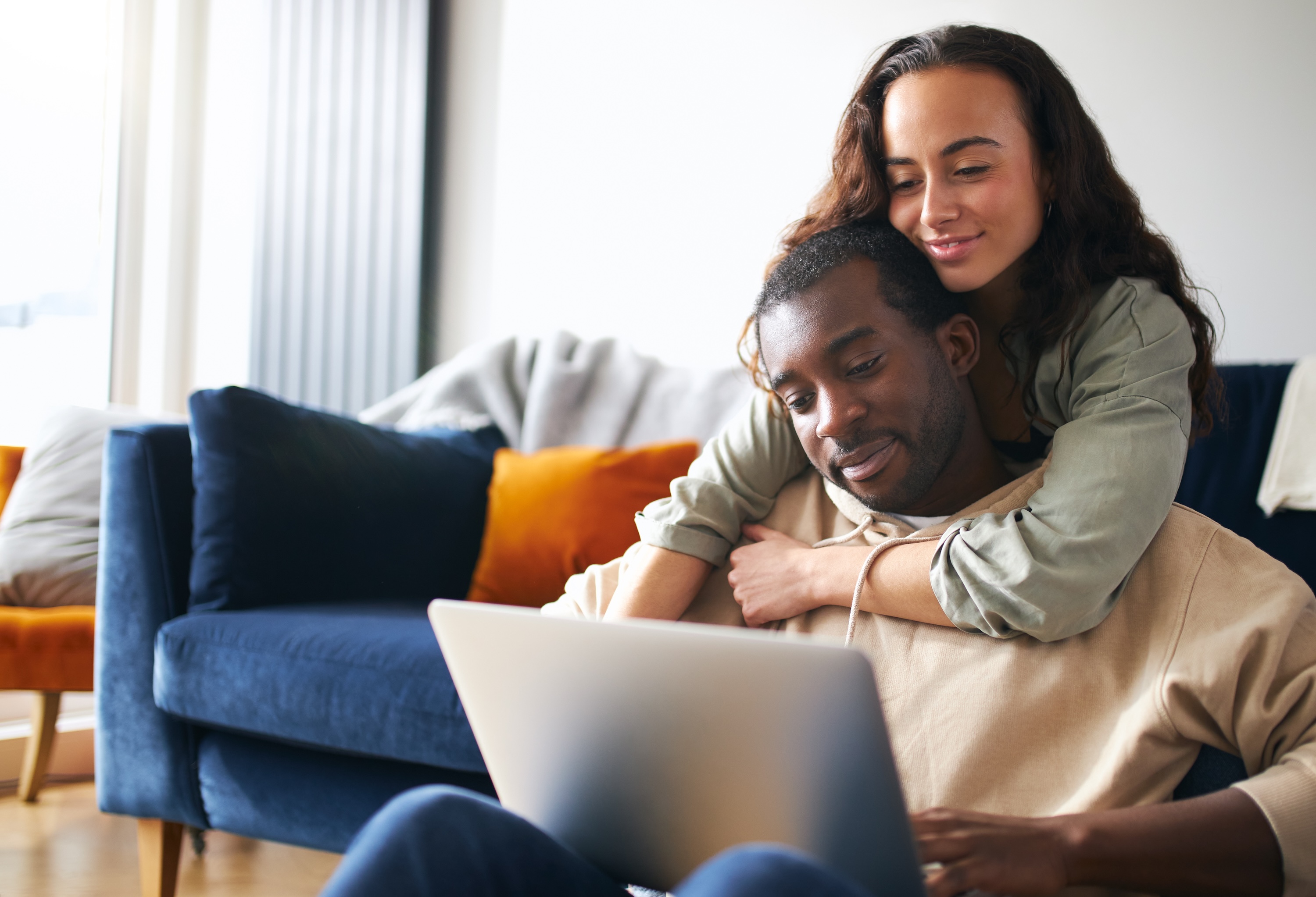 Couple on couch on computer stock image