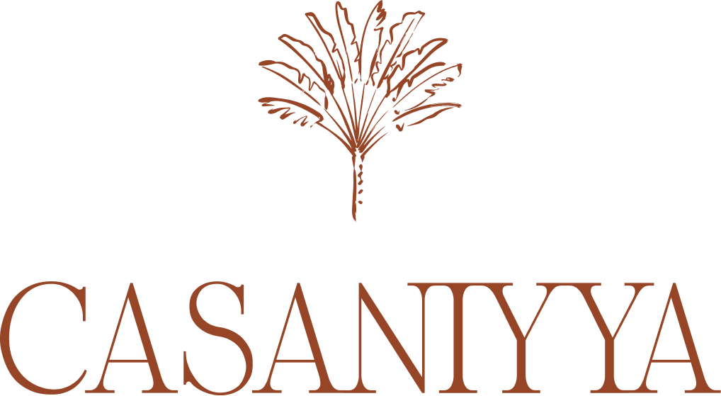 Logo de CasaNiyya représentant un palmier stylisé au-dessus du nom de la marque en élégantes lettres serif.
