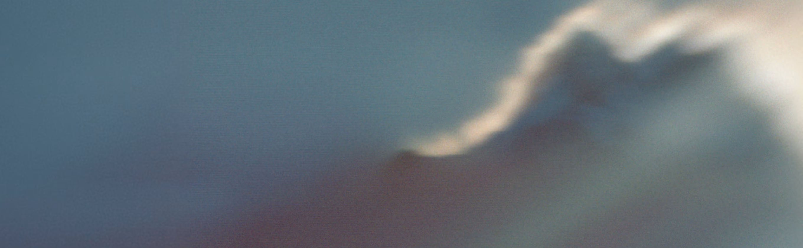 Mountain ridge dissolving into cloud