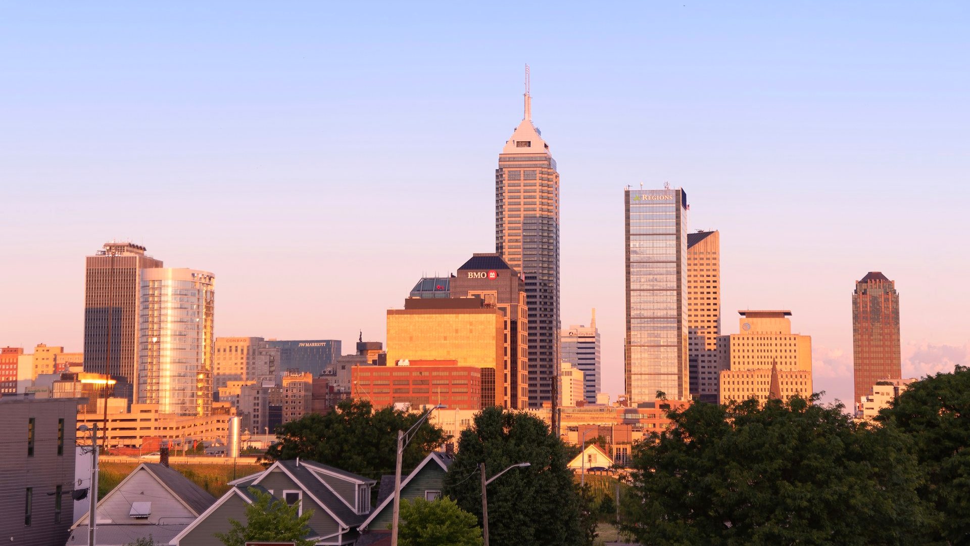 Downtown Indianapolis skyline at golden hour under a clear sky