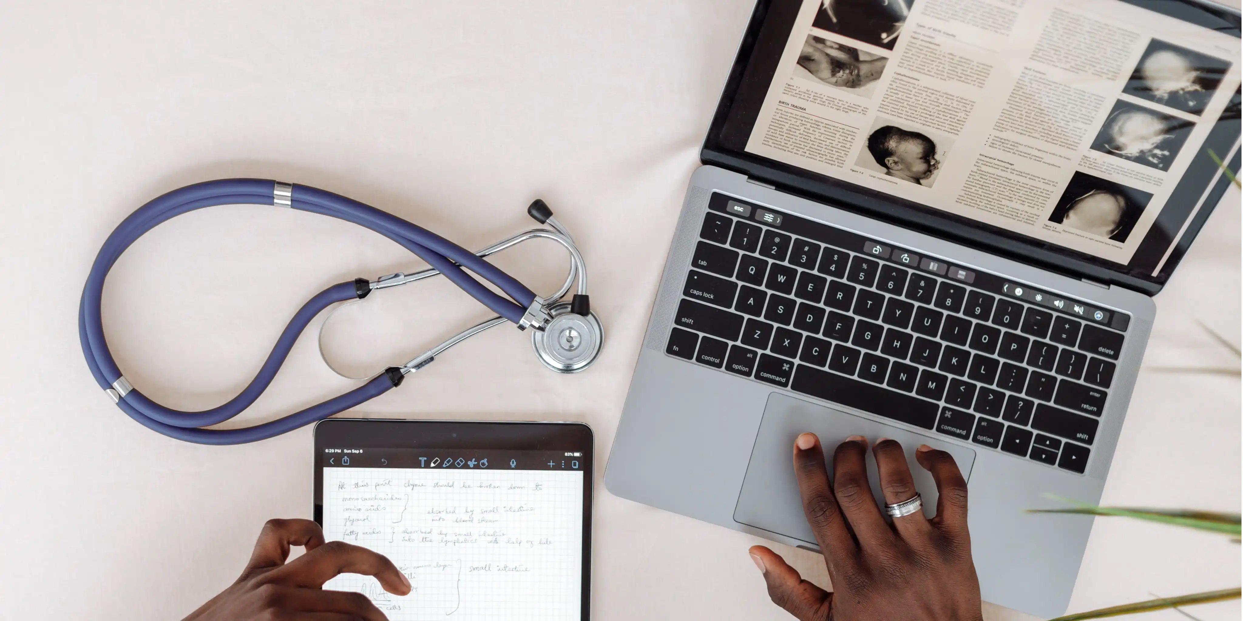 Hands using a laptop showing medical images