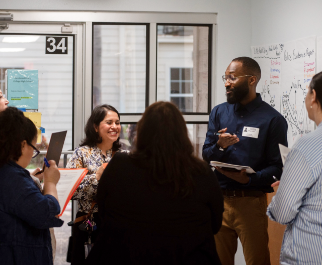 Instruction Partners team member speaking with educators