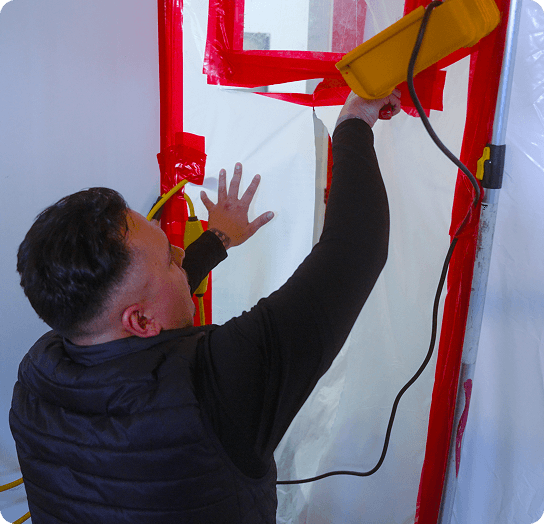 Technician sealing a containment barrier