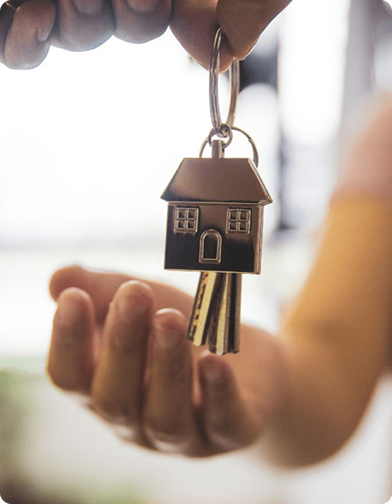 Hand holding house keys, a property owner ready to plan remediation