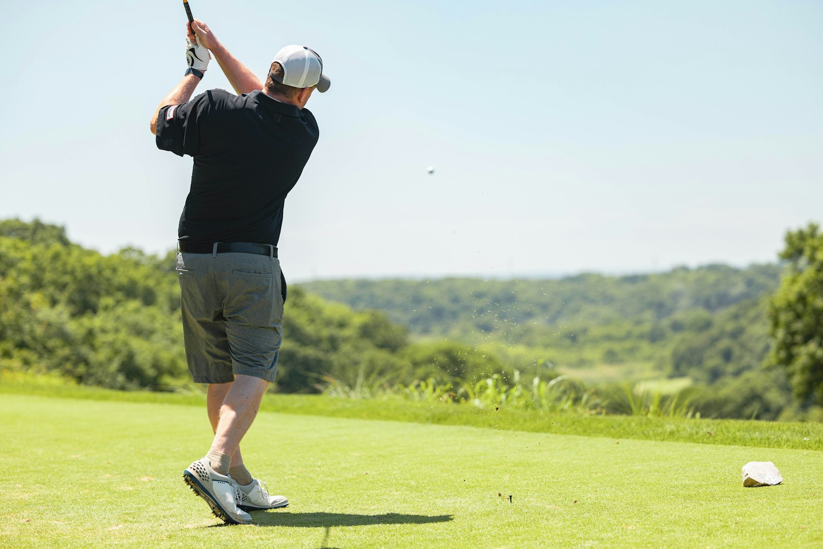 Golfer holding a golf club on a Simsbury course