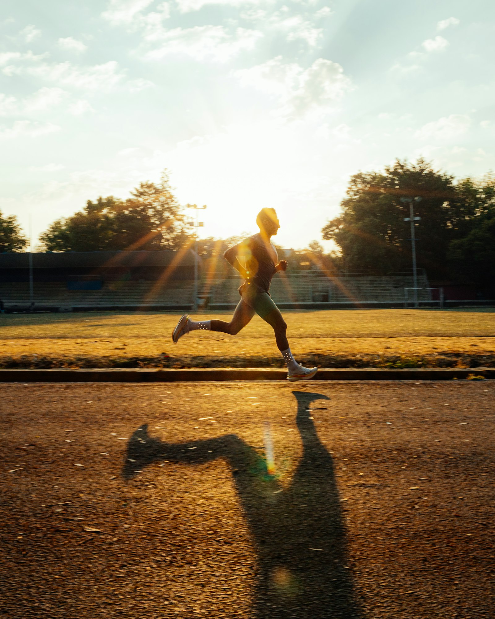 Sprinter racing on a track, illustrating acute hamstring injury risk