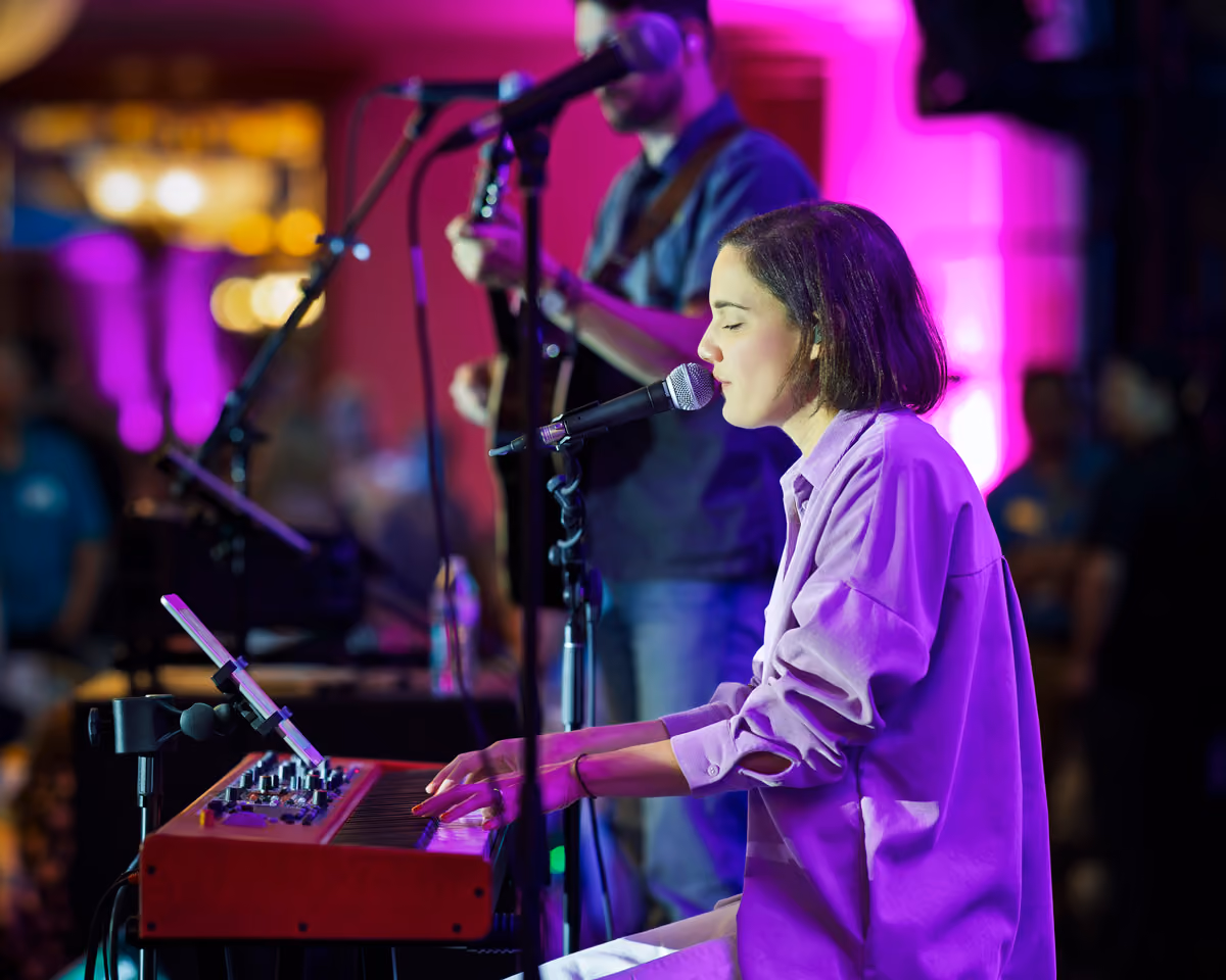 Rescue Live! musician singing and playing the piano on stage