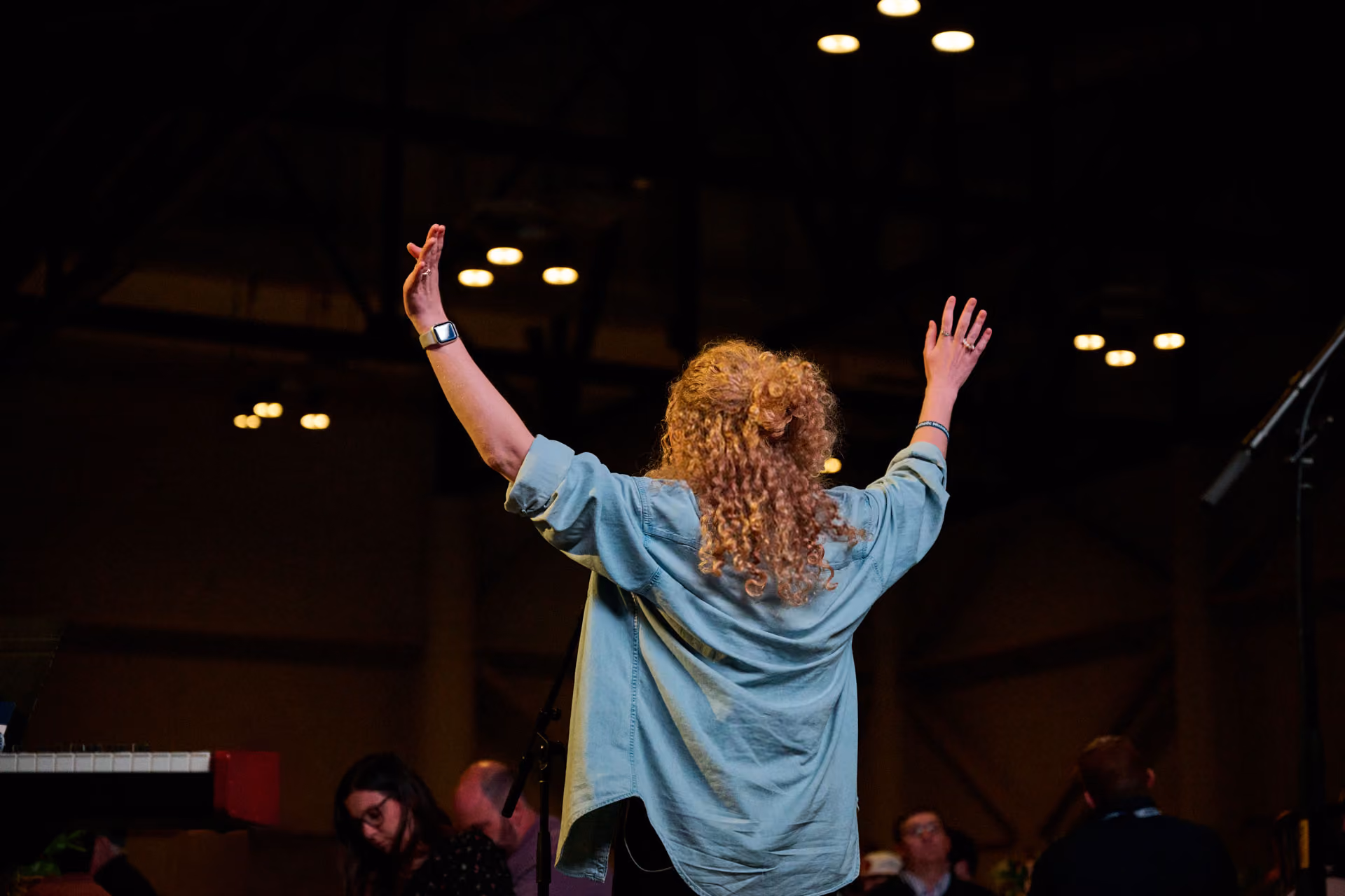 Woman worshipping with her hands in the air