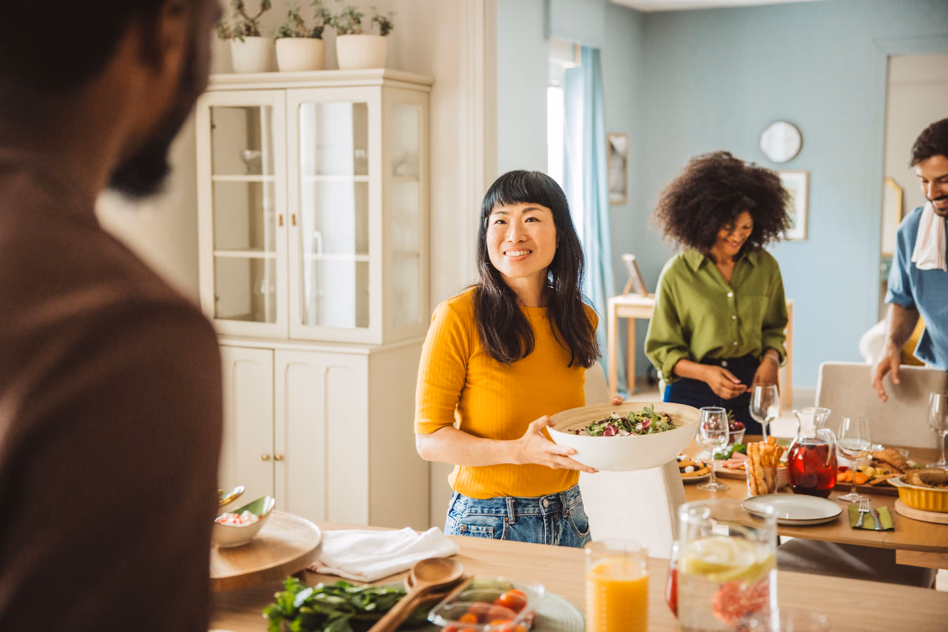 Woman smiling as she preps food for a gathering.