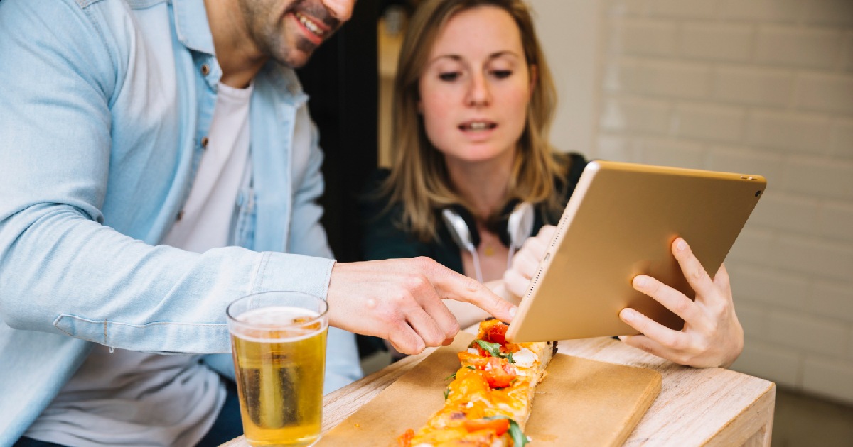 Pesquisa de satisfação em restaurantes e bares - casal responde a pesquisa em tablet