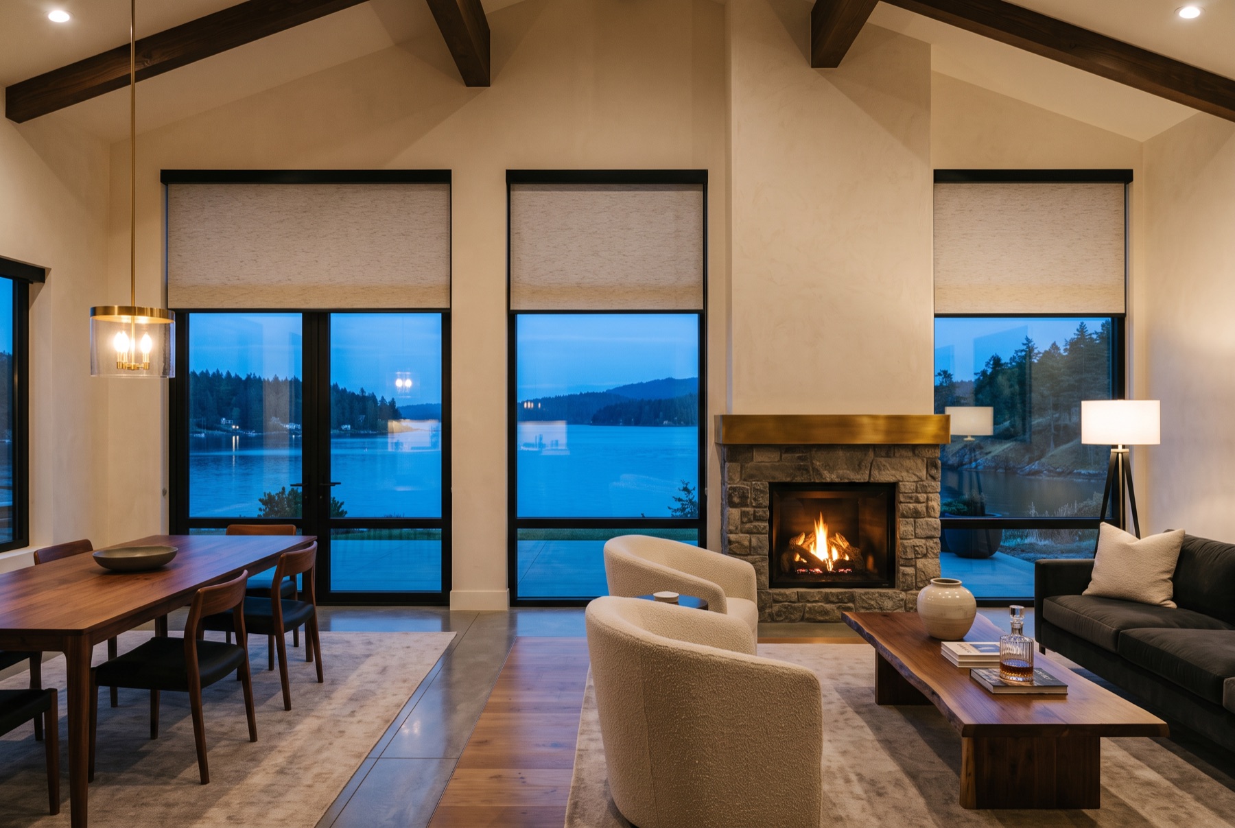 PowerView® motorized shades lowered in sync across a great room at dusk