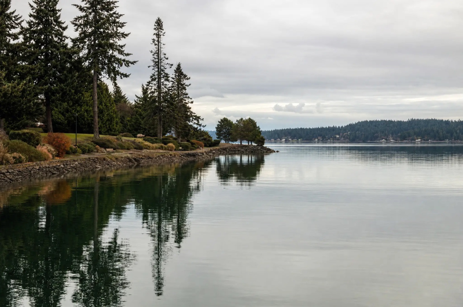 Calm water on Dyes Inlet at Silverdale with an evergreen shoreline