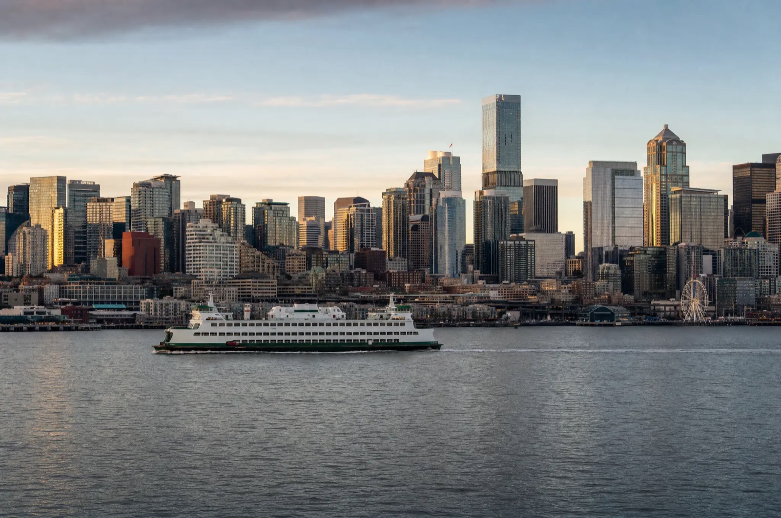 Seattle skyline from Elliott Bay with a ferry crossing in late-day light
