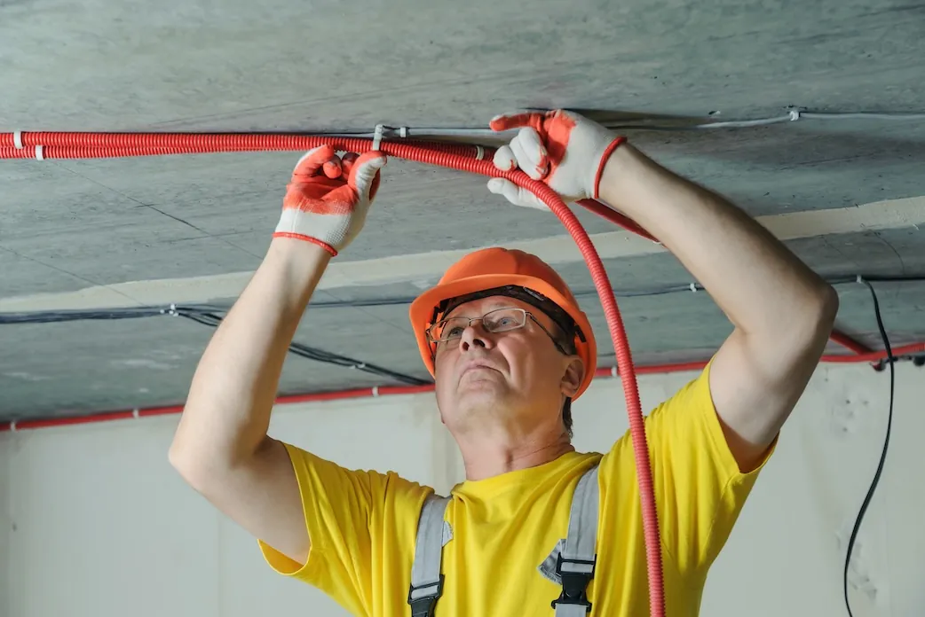 electrician-fixing-electric-corrugated-tube-ceiling