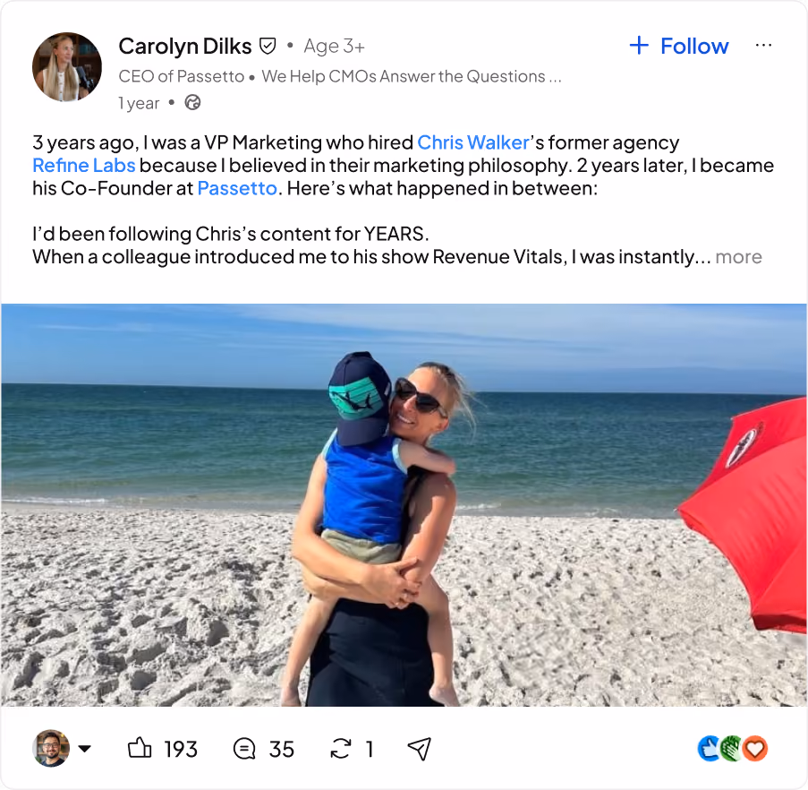 Woman wearing sunglasses holding child on a sandy beach with calm ocean and blue sky.