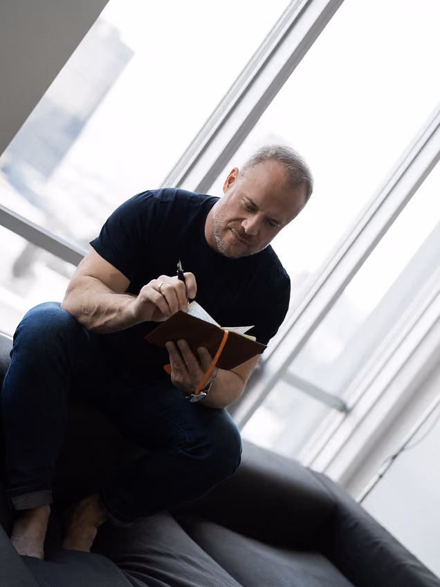 David Allison writing in a notebook