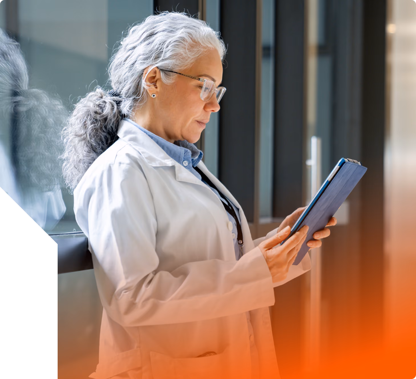 woman doctor with long grey hair looking at ipad