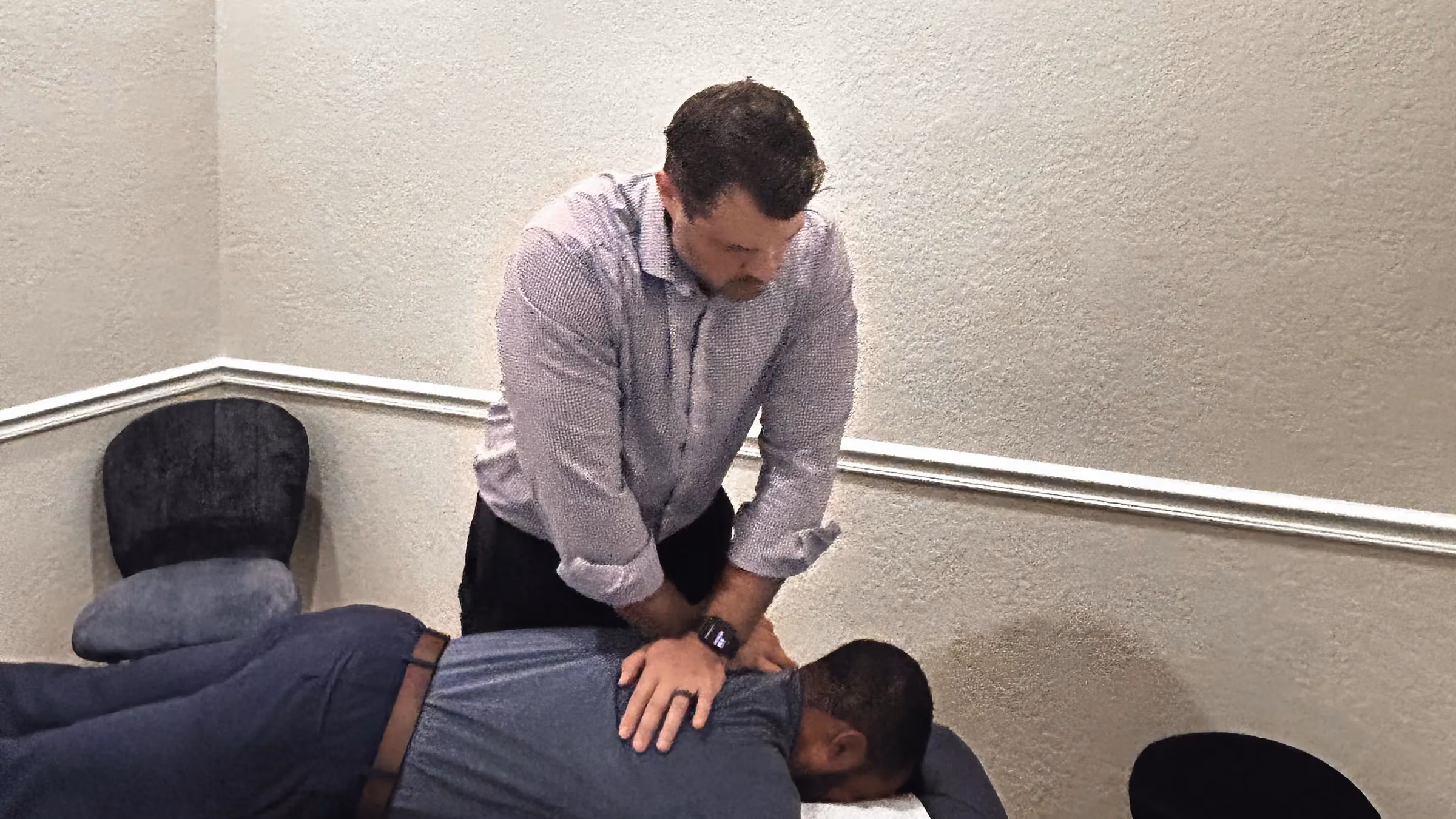 Chiropractor adjusting a patient’s lower back