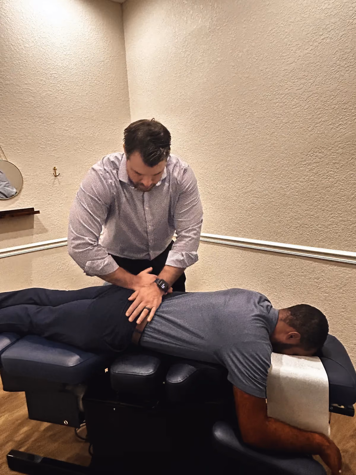 Chiropractor adjusting a patient’s lower back