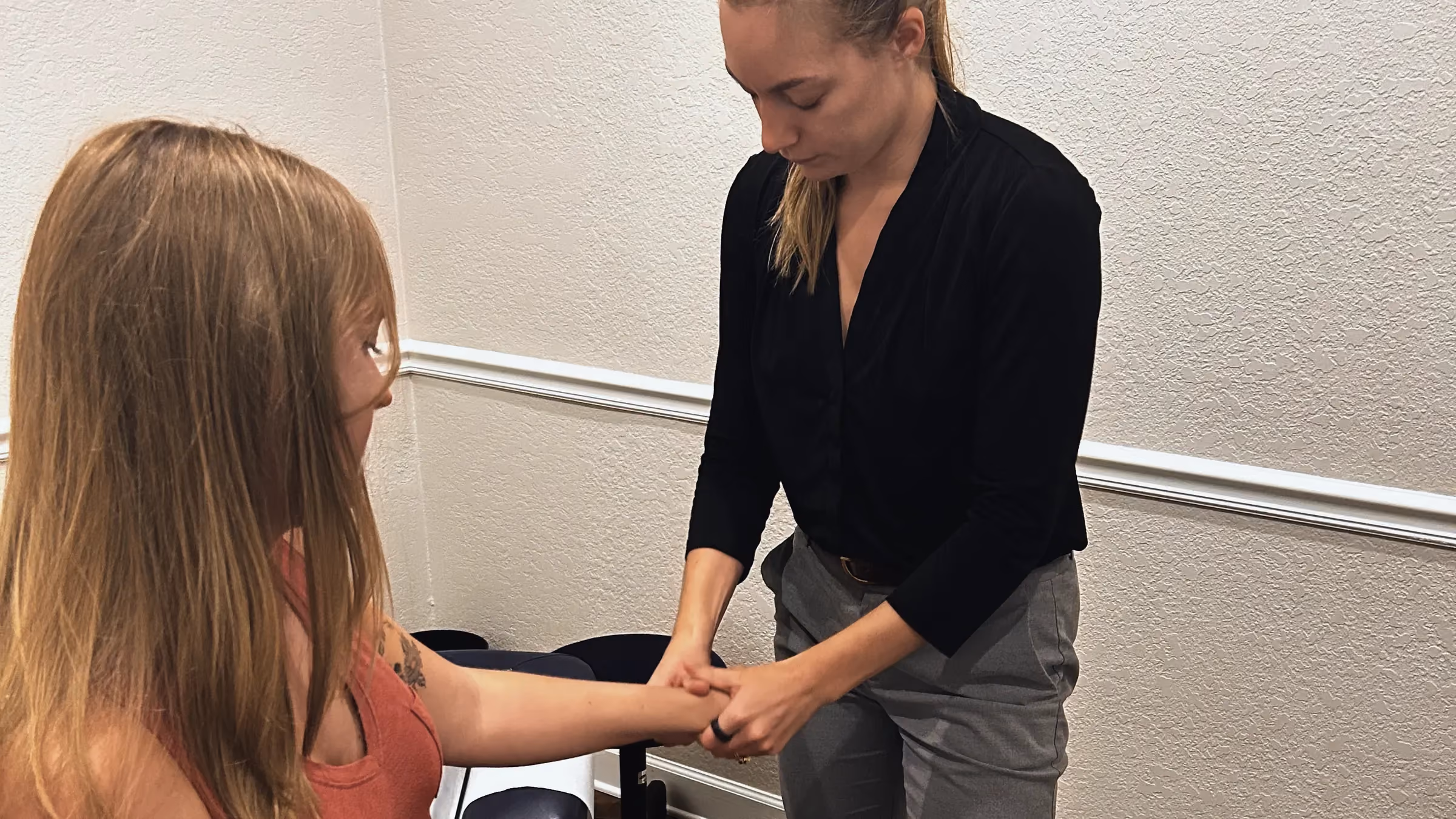 Dr. Magi assessing a patient’s wrist and forearm