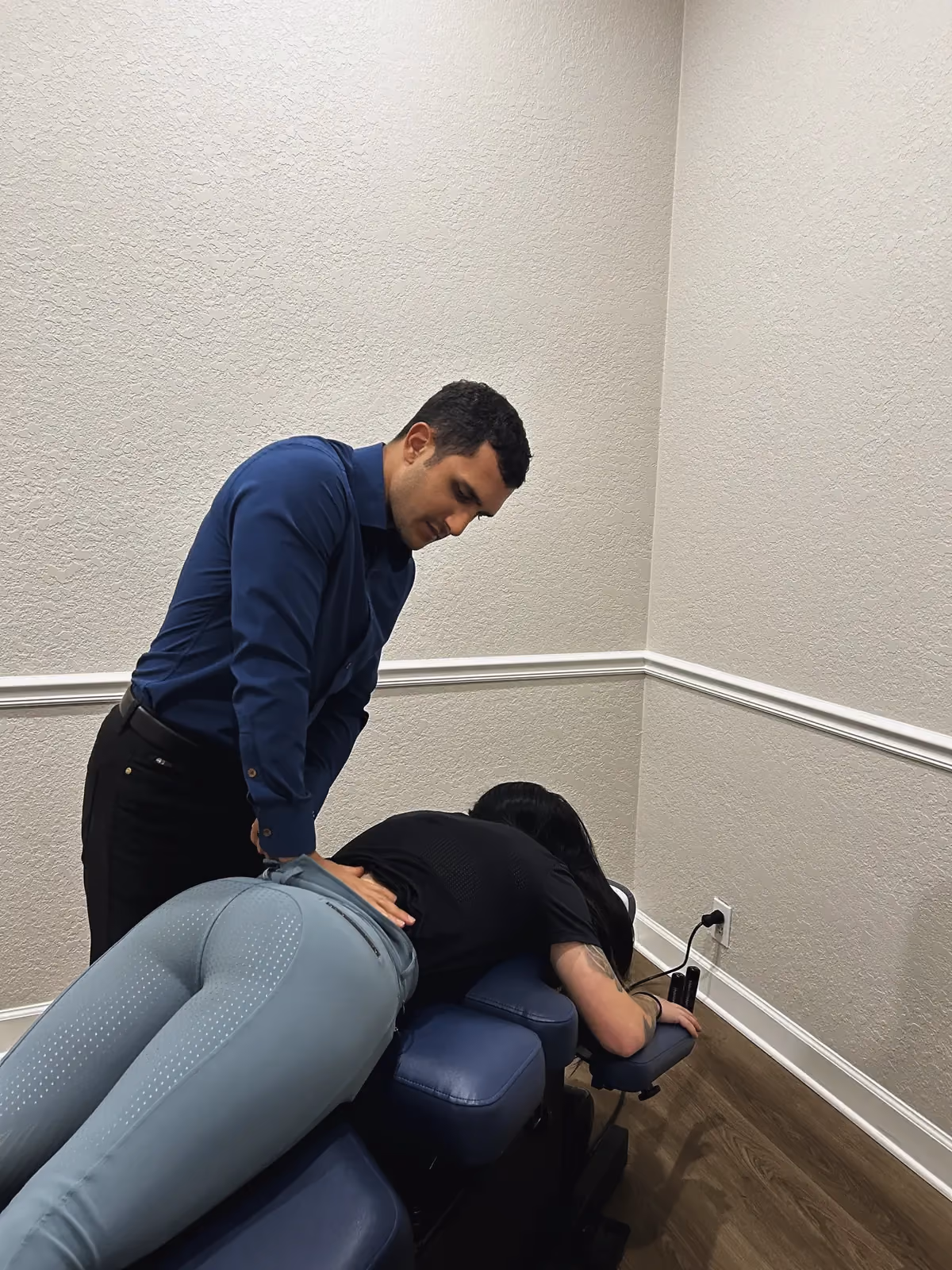 Dr. Z performing a chiropractic adjustment
