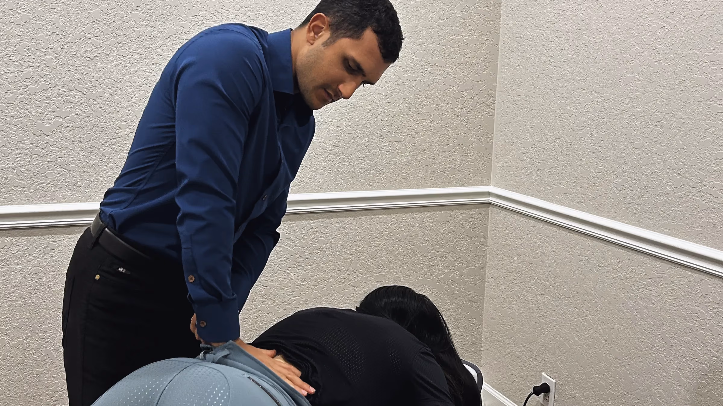 Dr. Z performing a chiropractic adjustment