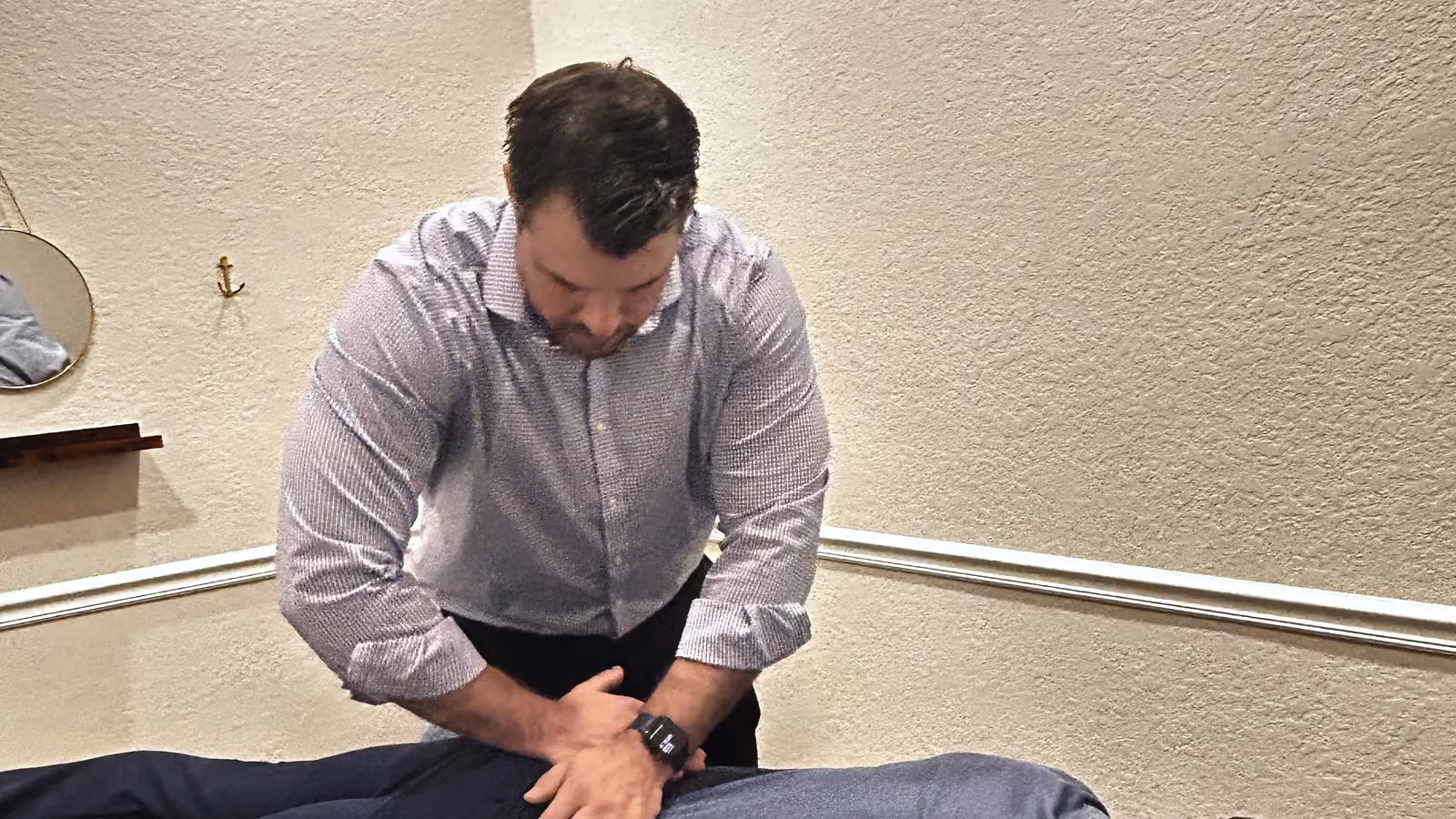 Chiropractor adjusting a patient’s lower back