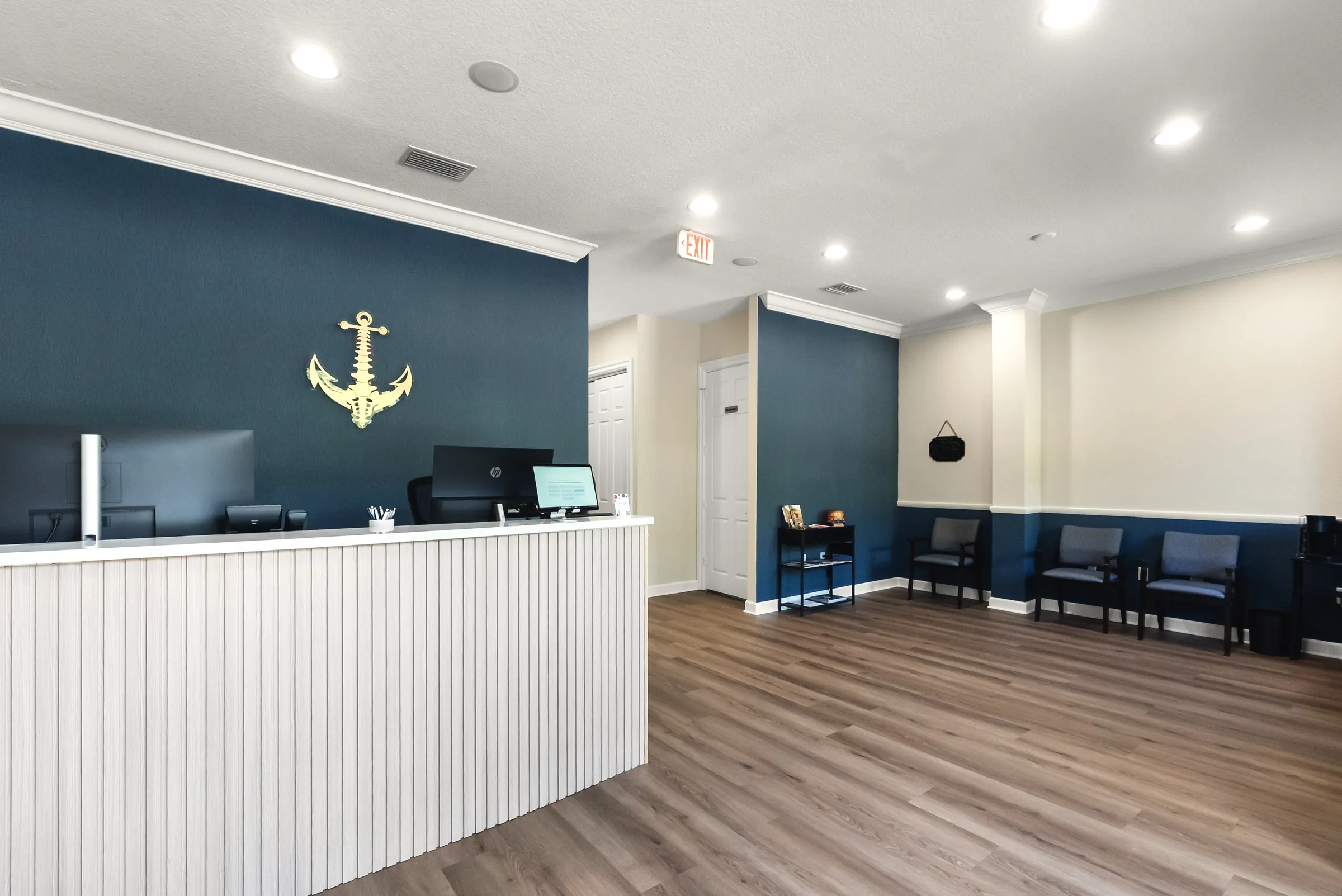 Front desk and gold anchor logo at the Stuart office