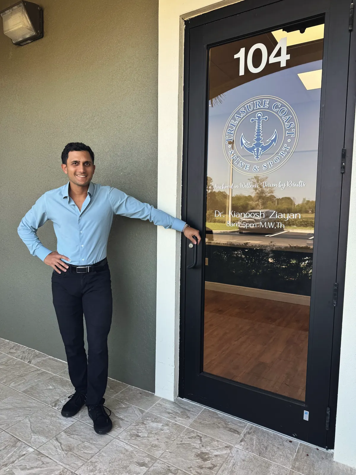 Dr. Kianoosh Ziayan at the entrance to the Port St. Lucie office