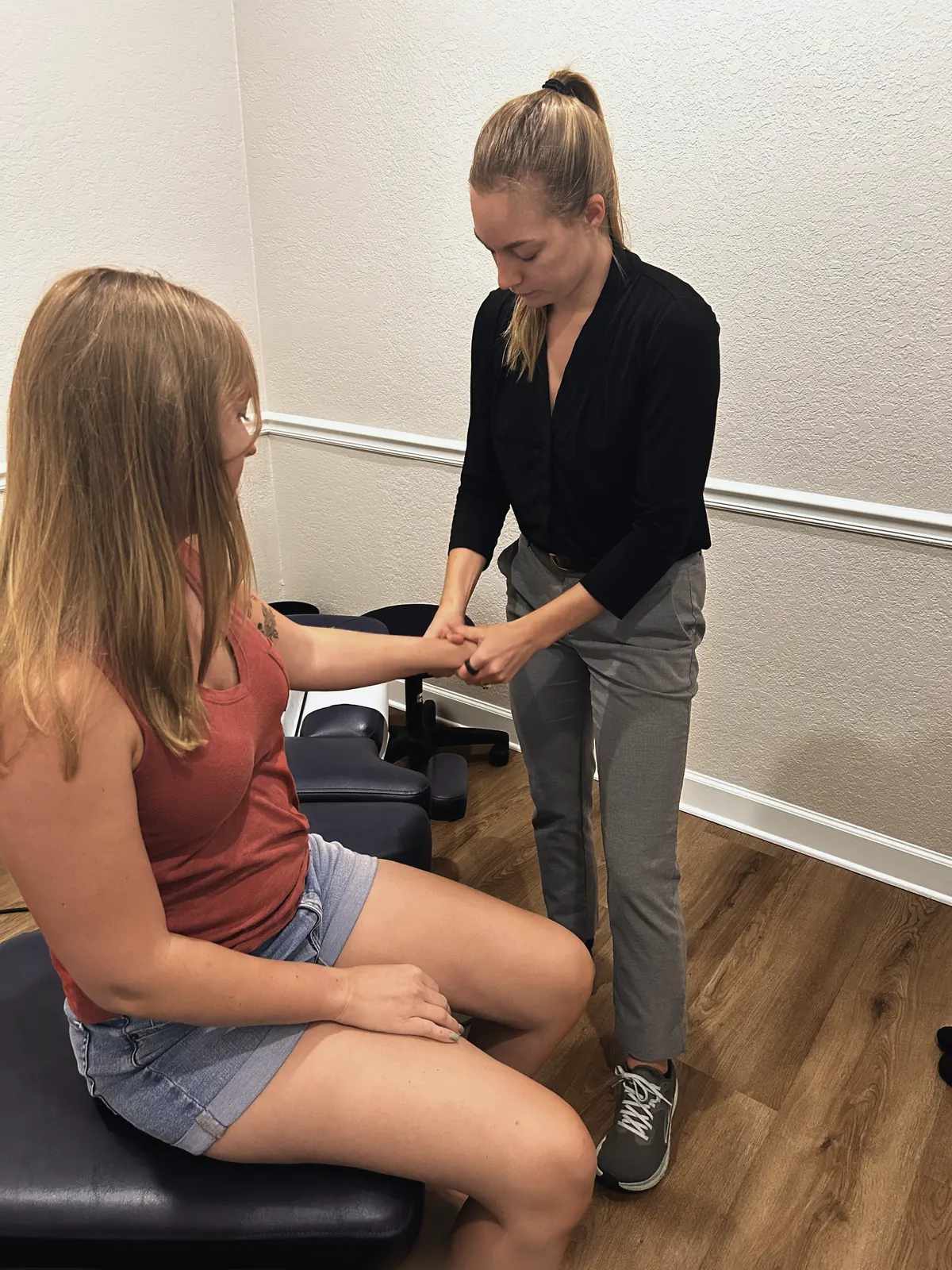 Dr. Magi assessing a patient’s wrist and forearm