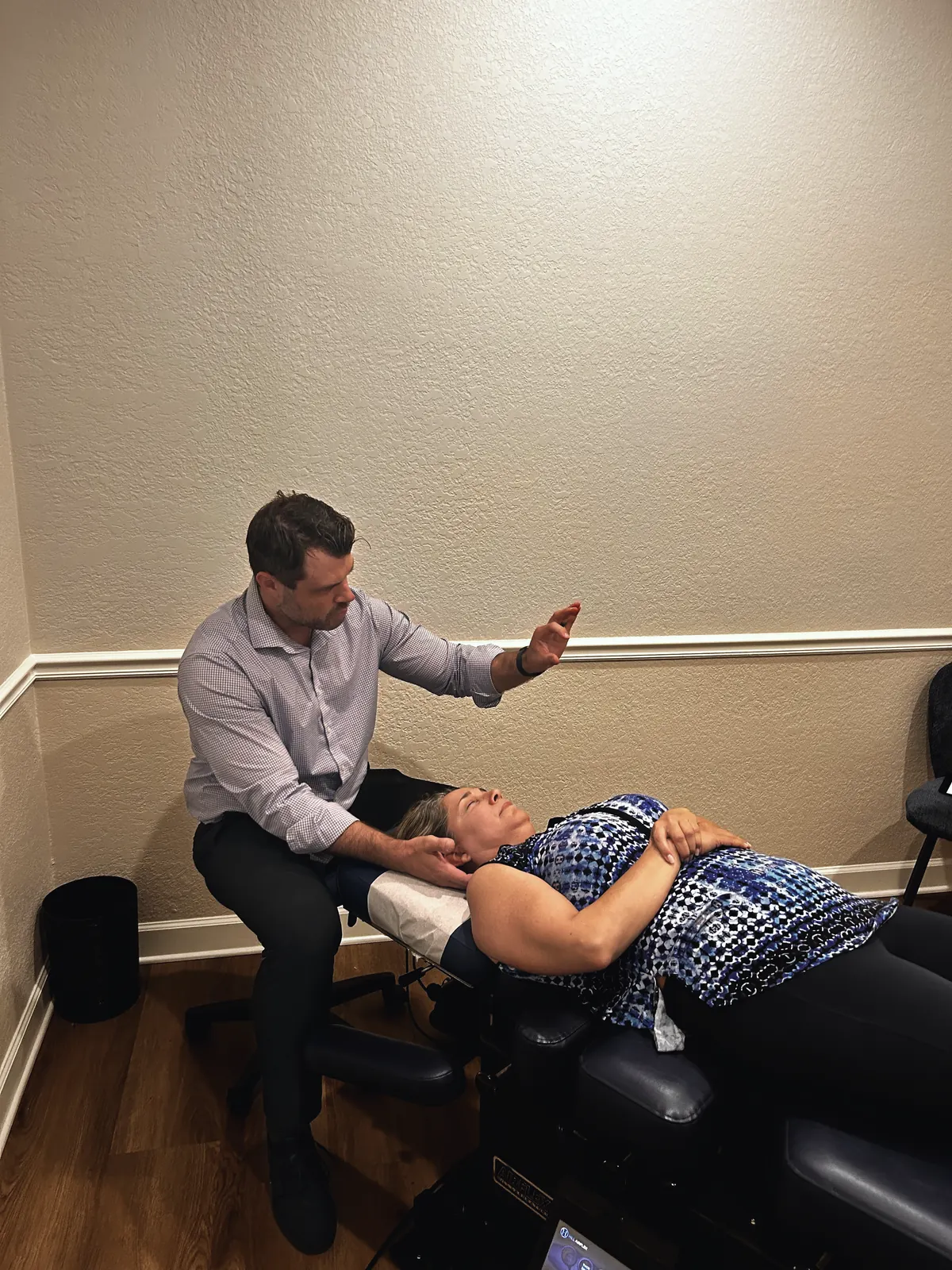 Chiropractor explaining neck treatment to a patient