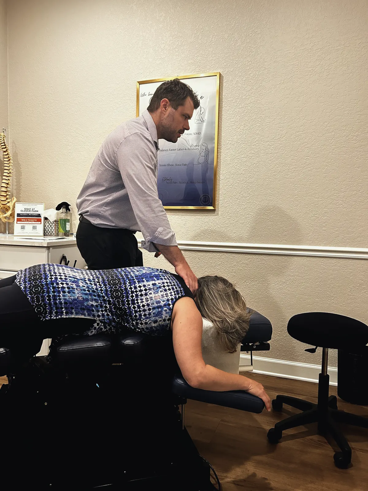 Chiropractor adjusting a patient’s upper back