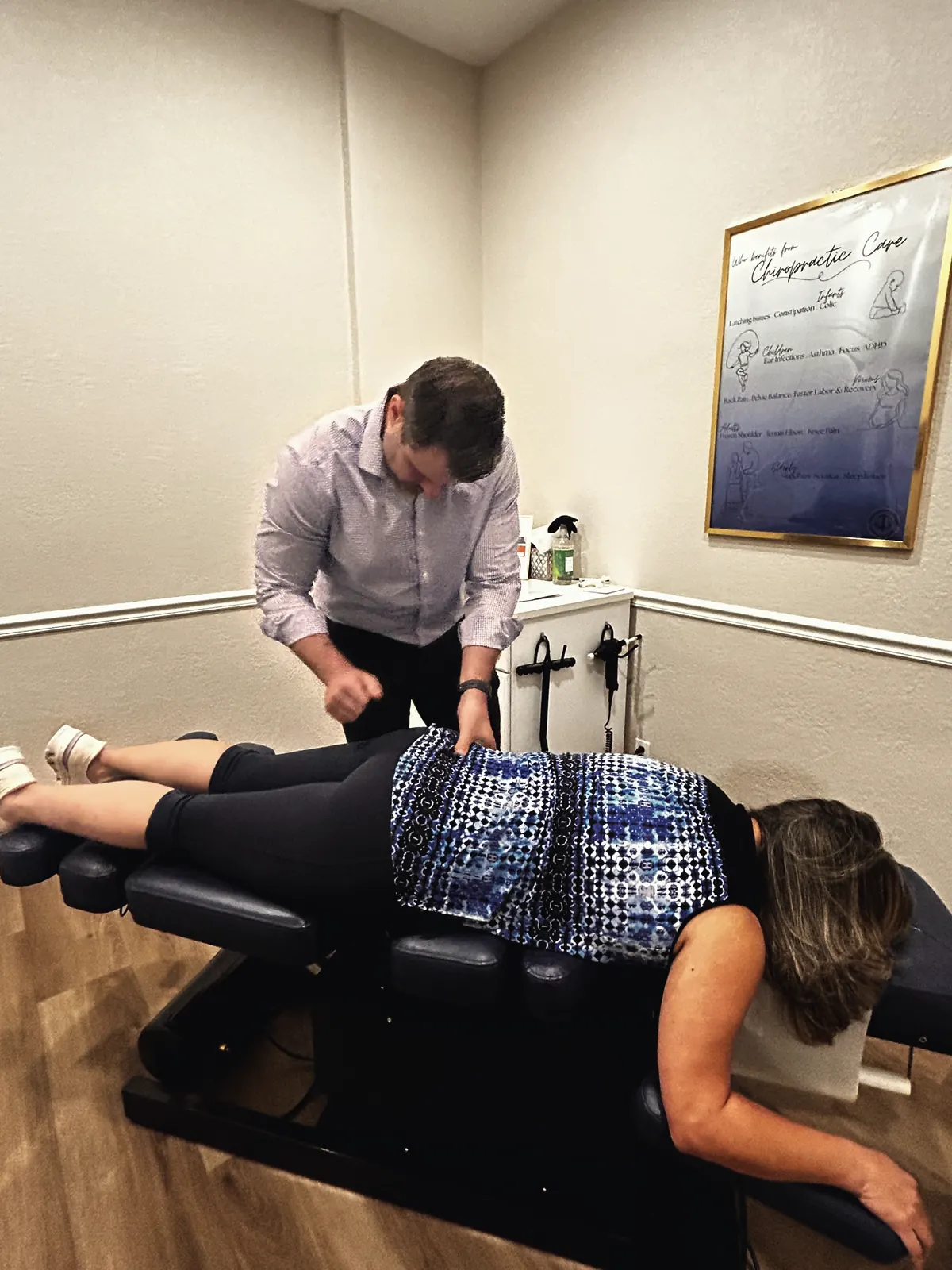 Chiropractor assessing a patient’s spine