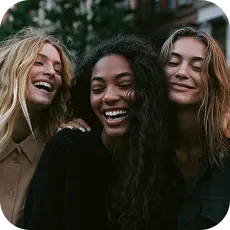 Three friends laughing together at night