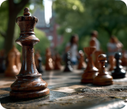 Close-up of a wooden king chess piece with blurred chessboard and pieces in the background.