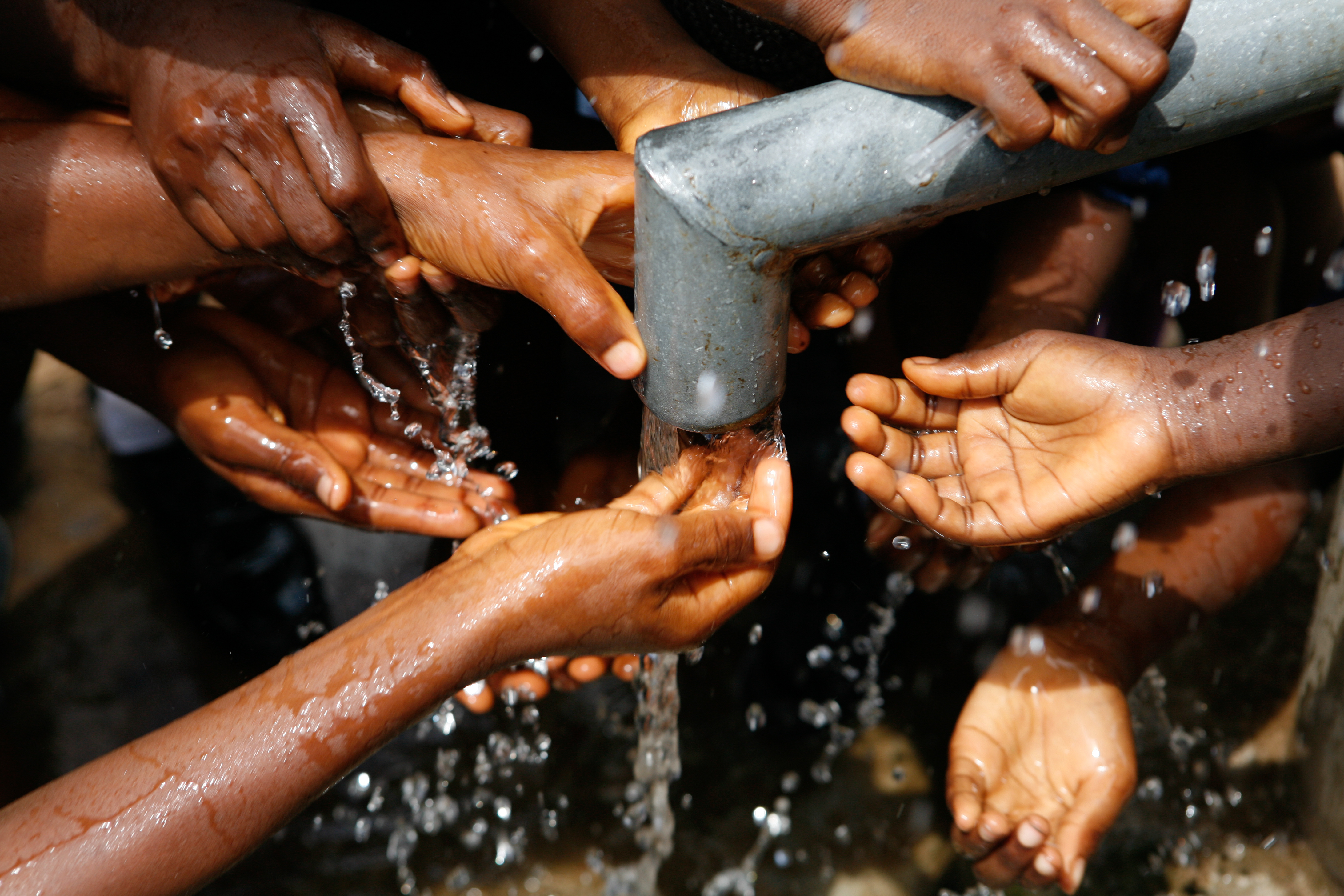 Children collecting water from a community tap stand