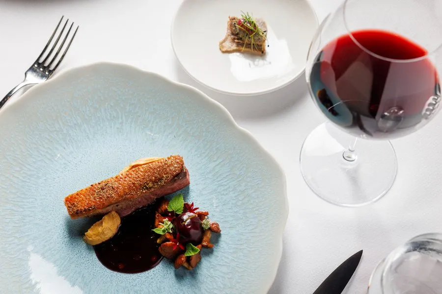 Seasonal duck entrée served as part of Amphora’s contemporary tasting menu with optional wine pairing.