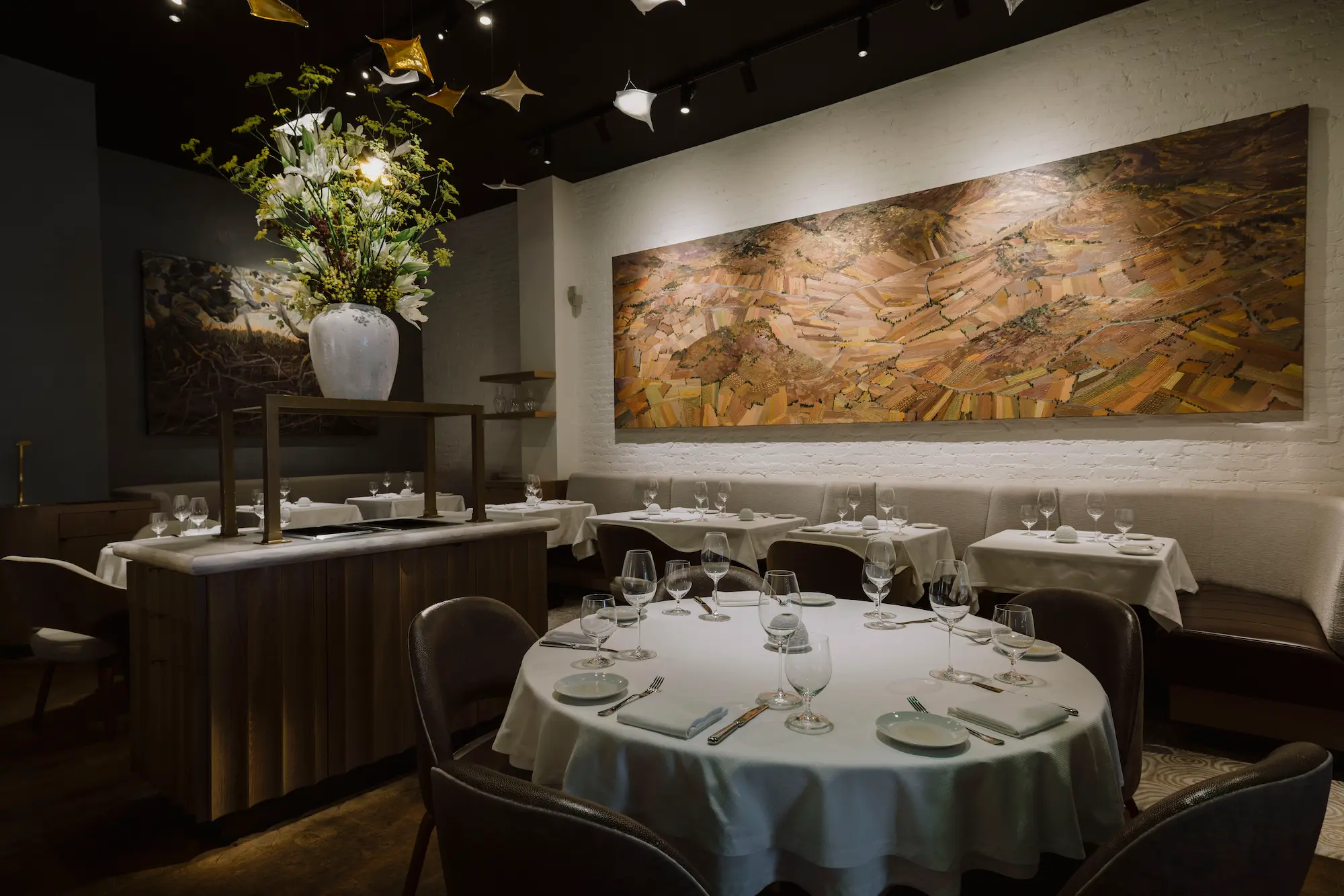 Elegant dining room at Amphora restaurant in Manhattan's Flatiron District featuring contemporary design, seasonal floral arrangements, and refined fine dining tables.